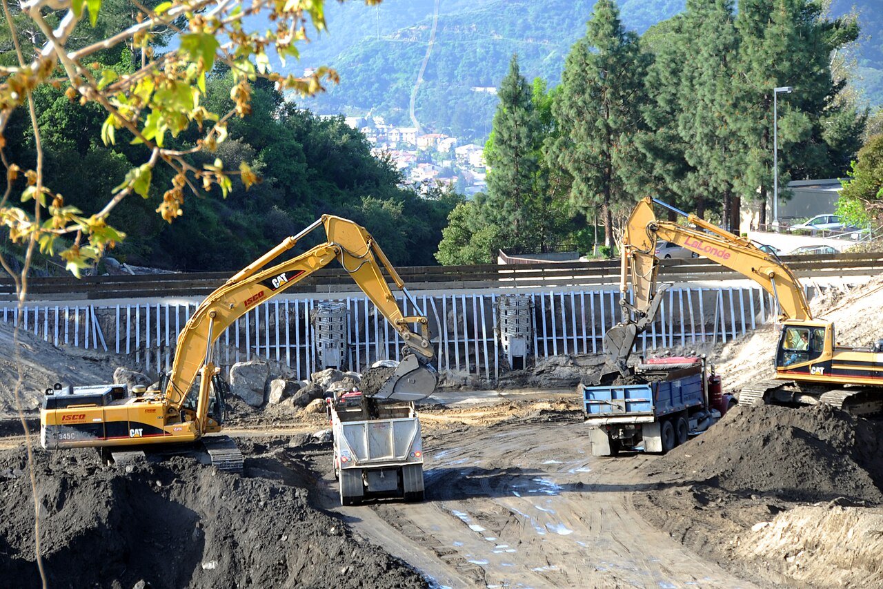 Pasadena, CA-- A debris basin at Pickins yard is cleaned after severe winter weather caused flooding and landslides to fill the bowl. Under the Hazard Mitigation Grant Program, The Flintridge community adopted the basins as a way to mitigate the repetive losses caused by annual flooding. Adam DuBrowa/FEMA